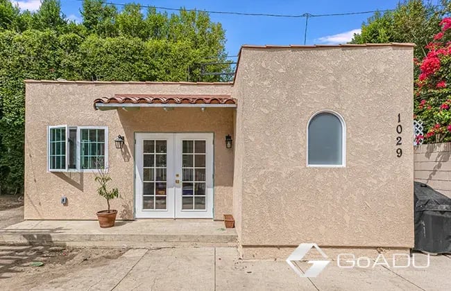 Spanish style ADU in Los Angeles with two French doors and a portico